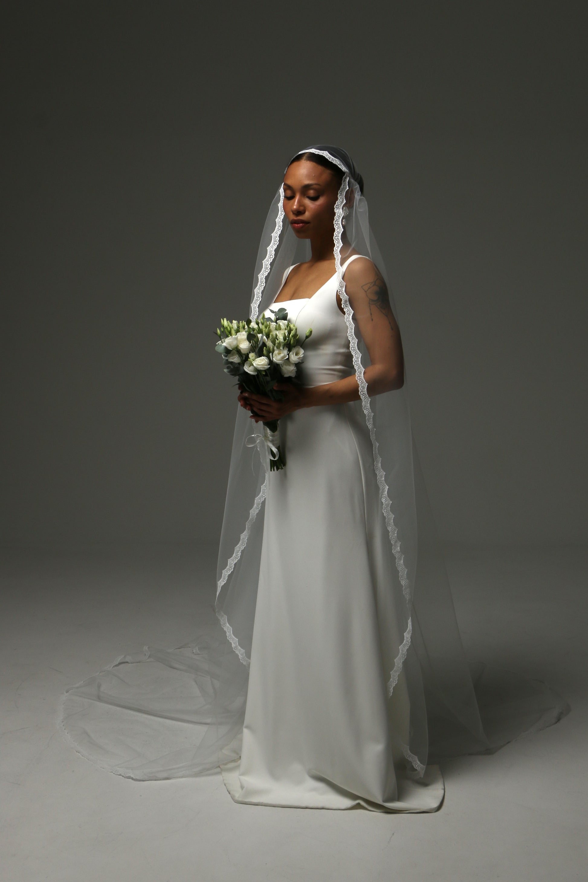 Elegant bridal veil with lace-trimmed edge and cathedral-length train.