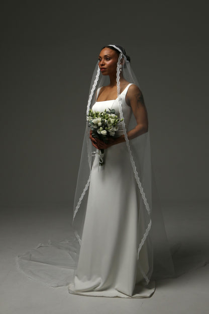 Vintage-inspired wedding veil flowing beautifully behind the bride.