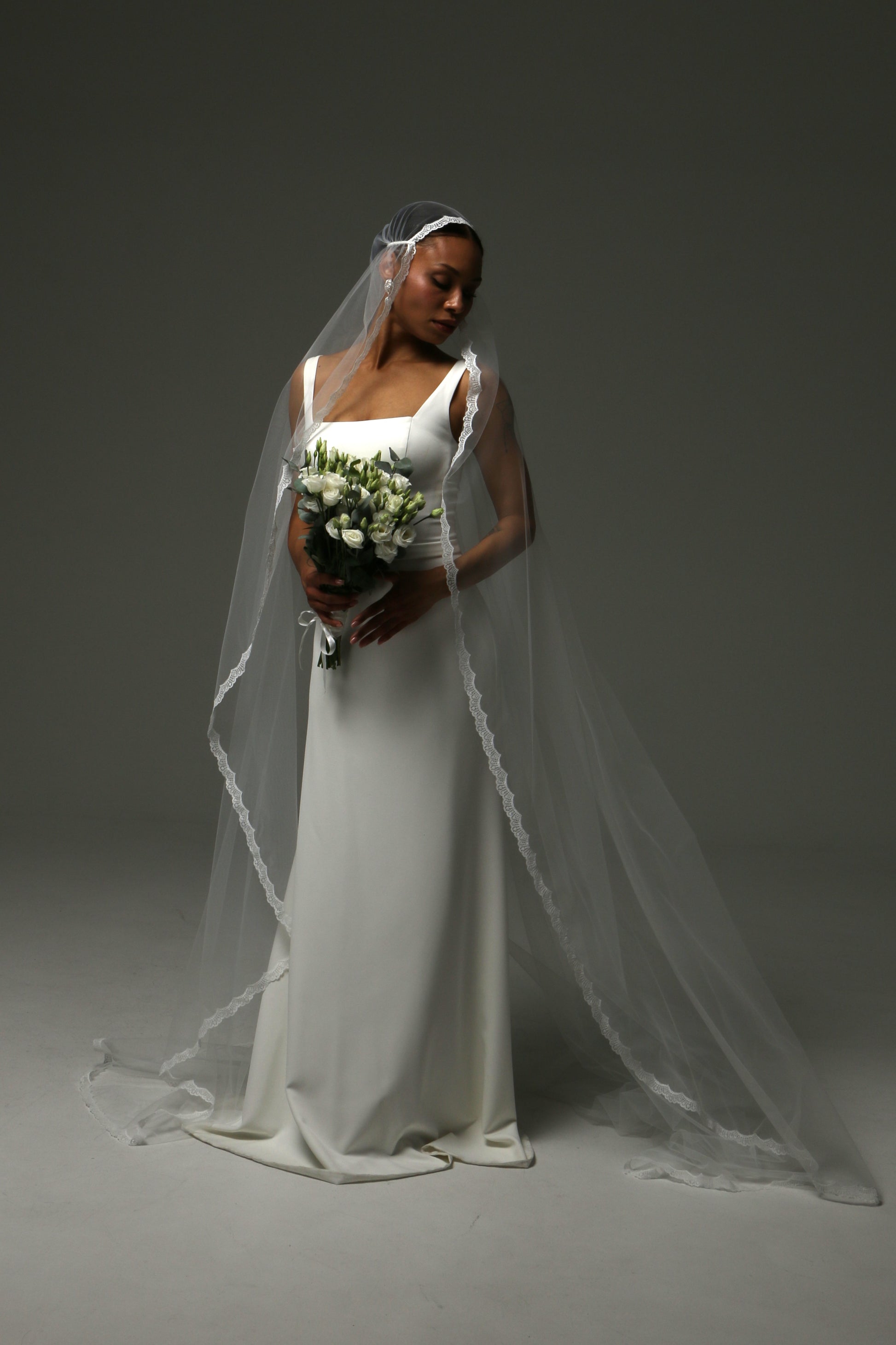 Soft ivory tulle veil creating a graceful bridal silhouette.
