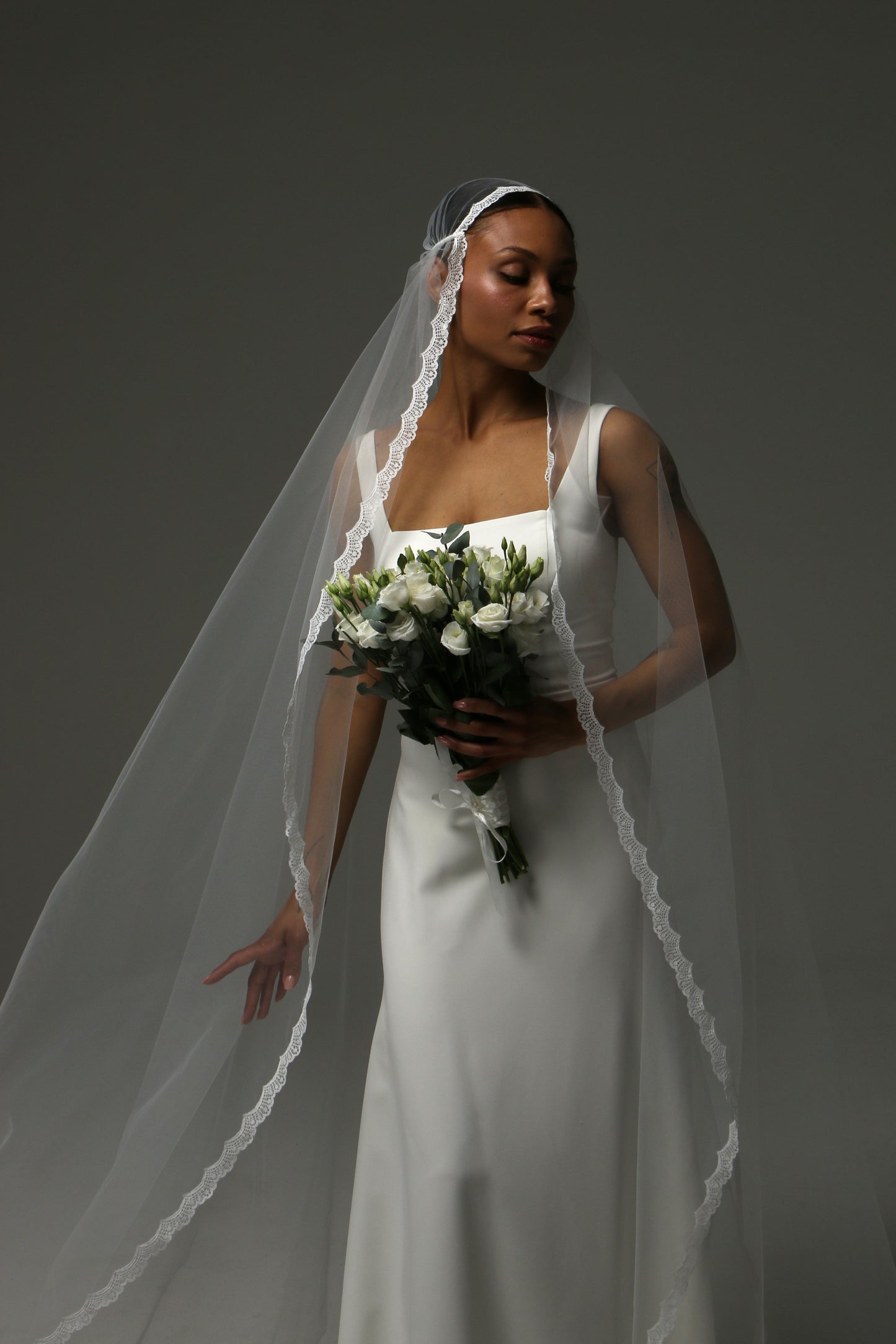 Romantic wedding veil with elegant lace edging and flowing silhouette.