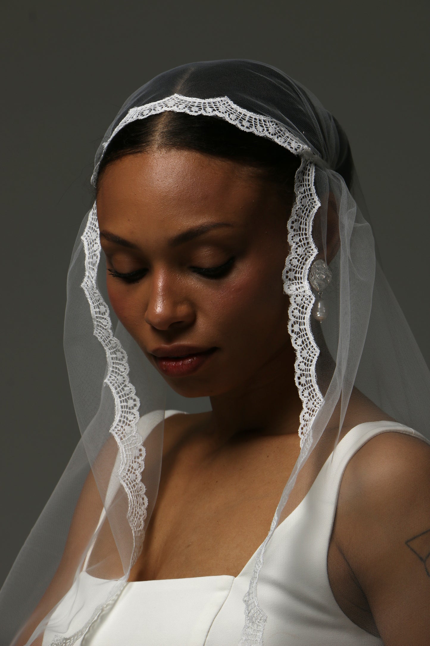 Soft tulle cathedral wedding veil featuring a classic Juliet cap design.