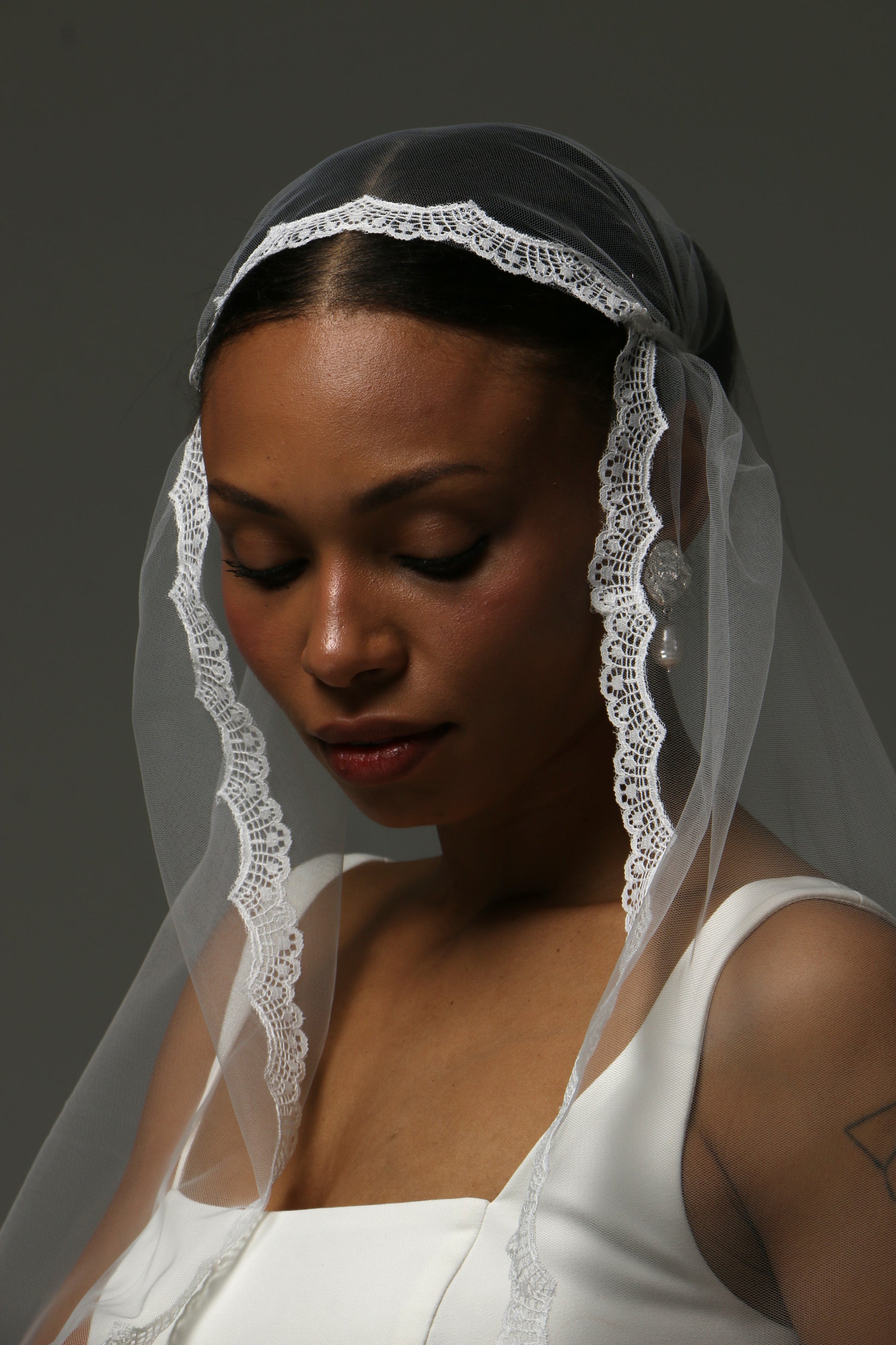 Soft tulle cathedral wedding veil featuring a classic Juliet cap design.