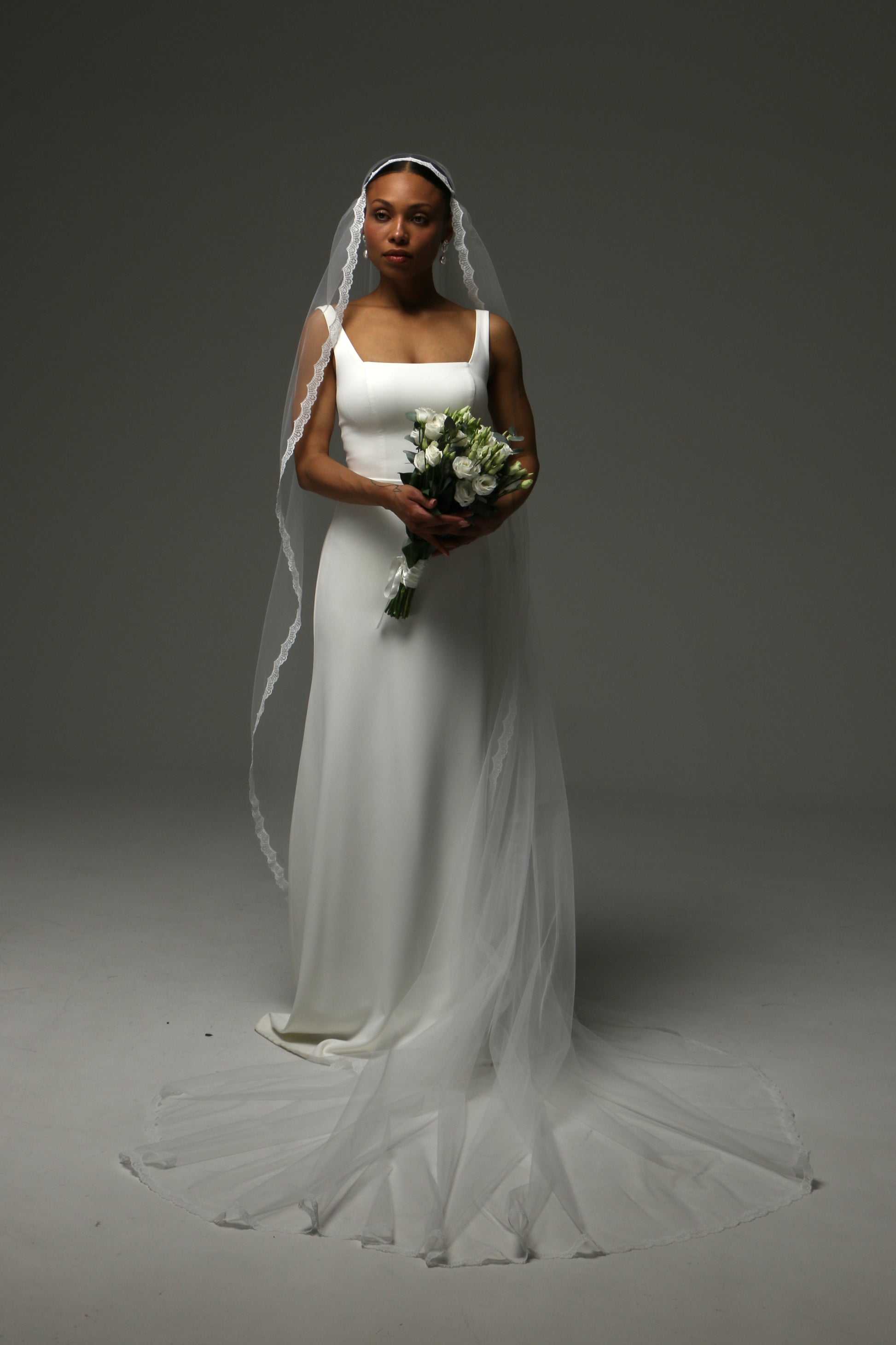 Lightweight cathedral veil with delicate scalloped lace edge.
