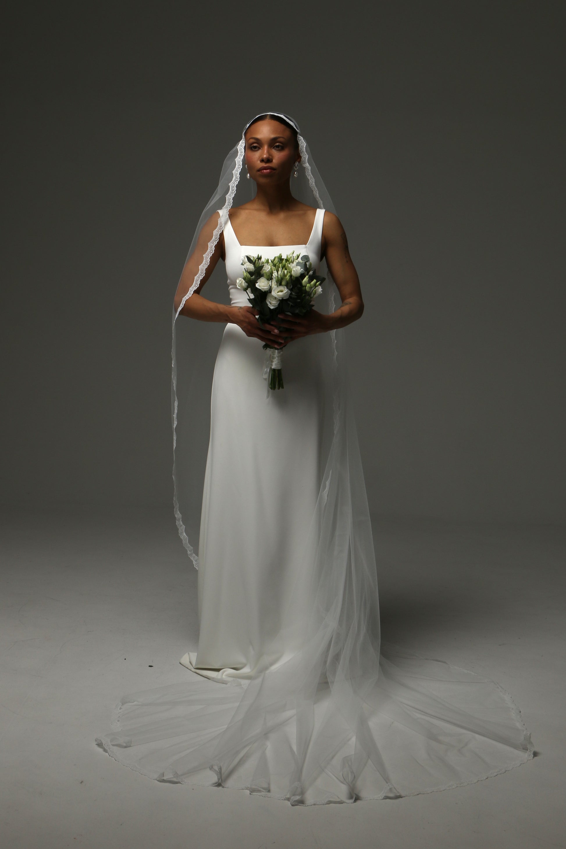 Timeless cathedral-length wedding veil with soft tulle and lace detailing.