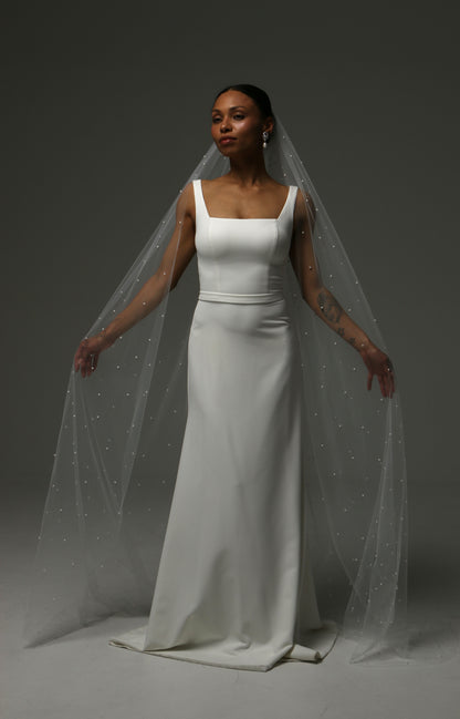 Soft illusion tulle wedding veil featuring scattered pearls throughout.