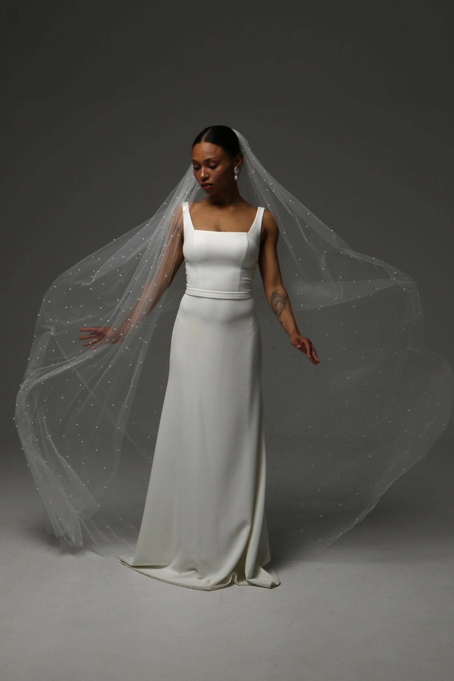 Romantic cathedral veil with luminous pearl embellishments.