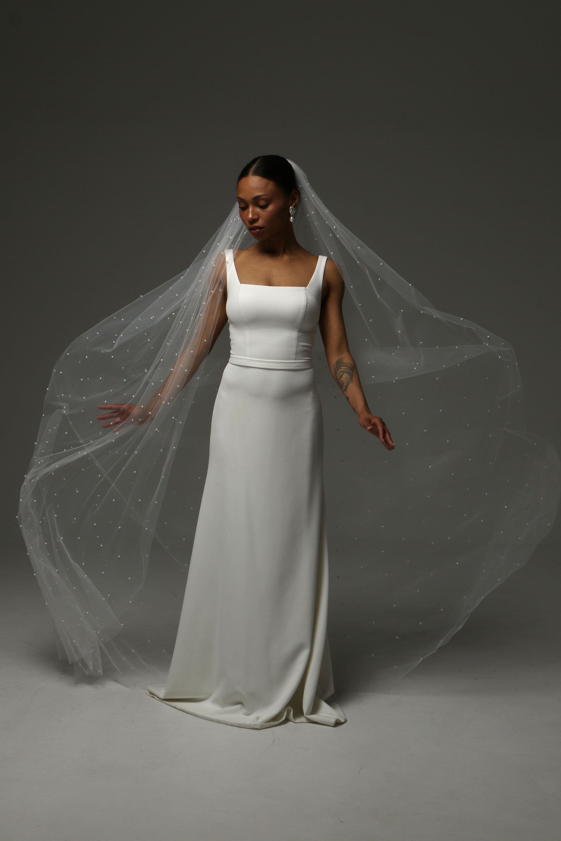 Romantic cathedral veil with luminous pearl embellishments.