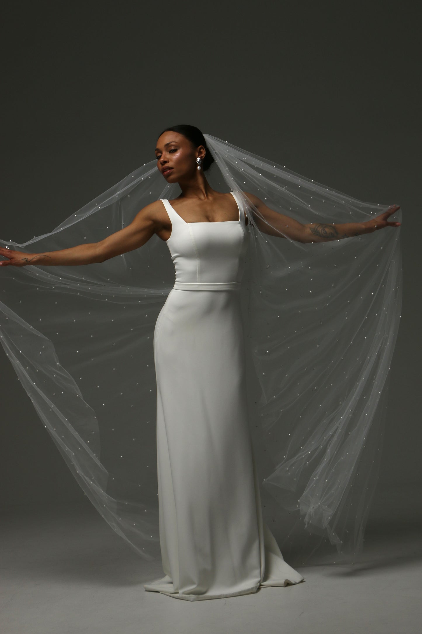 Cathedral pearl veil styled with a sleek satin wedding dress.