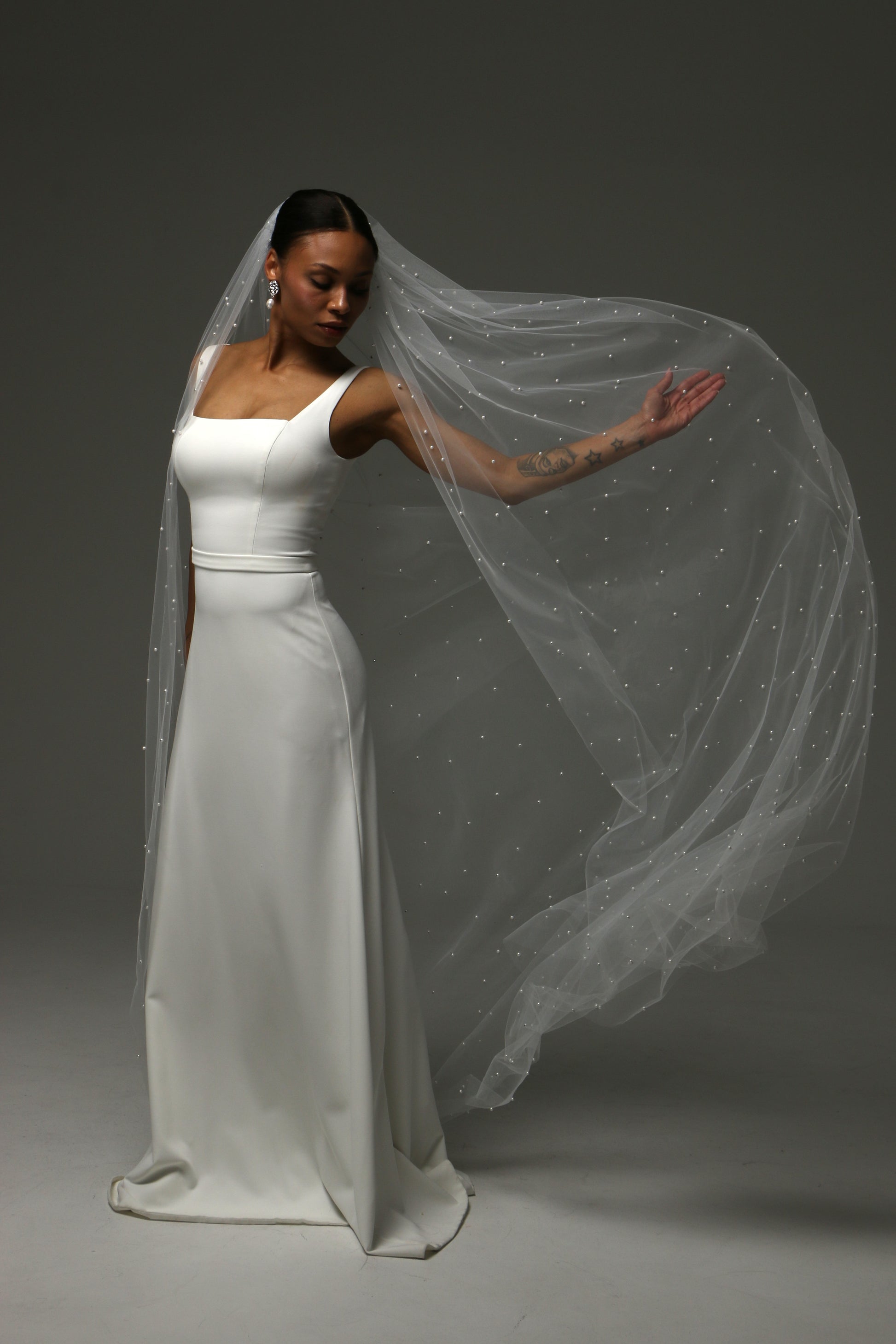 Close-up of delicate pearl accents on soft tulle bridal veil