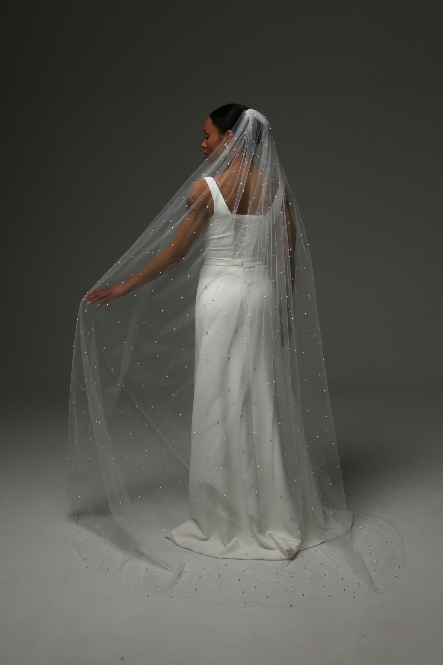 Long pearl veil creating a graceful bridal silhouette.