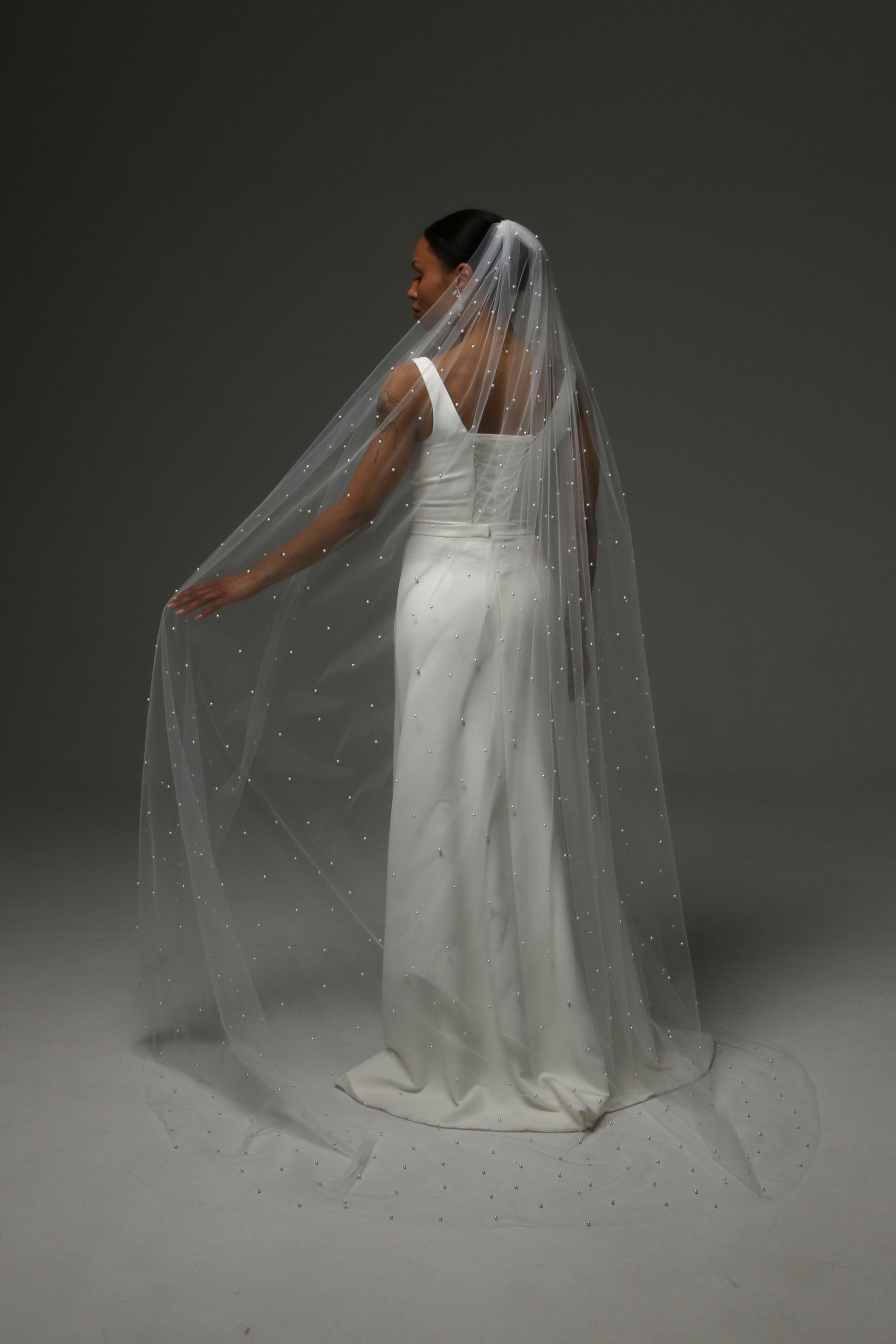 Long pearl veil creating a graceful bridal silhouette.