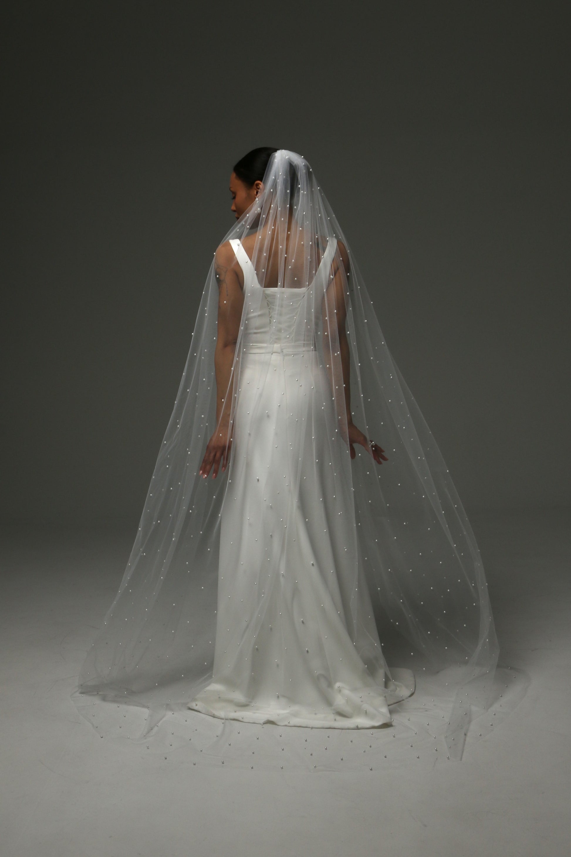 Lightweight cathedral-length veil with evenly scattered pearls.