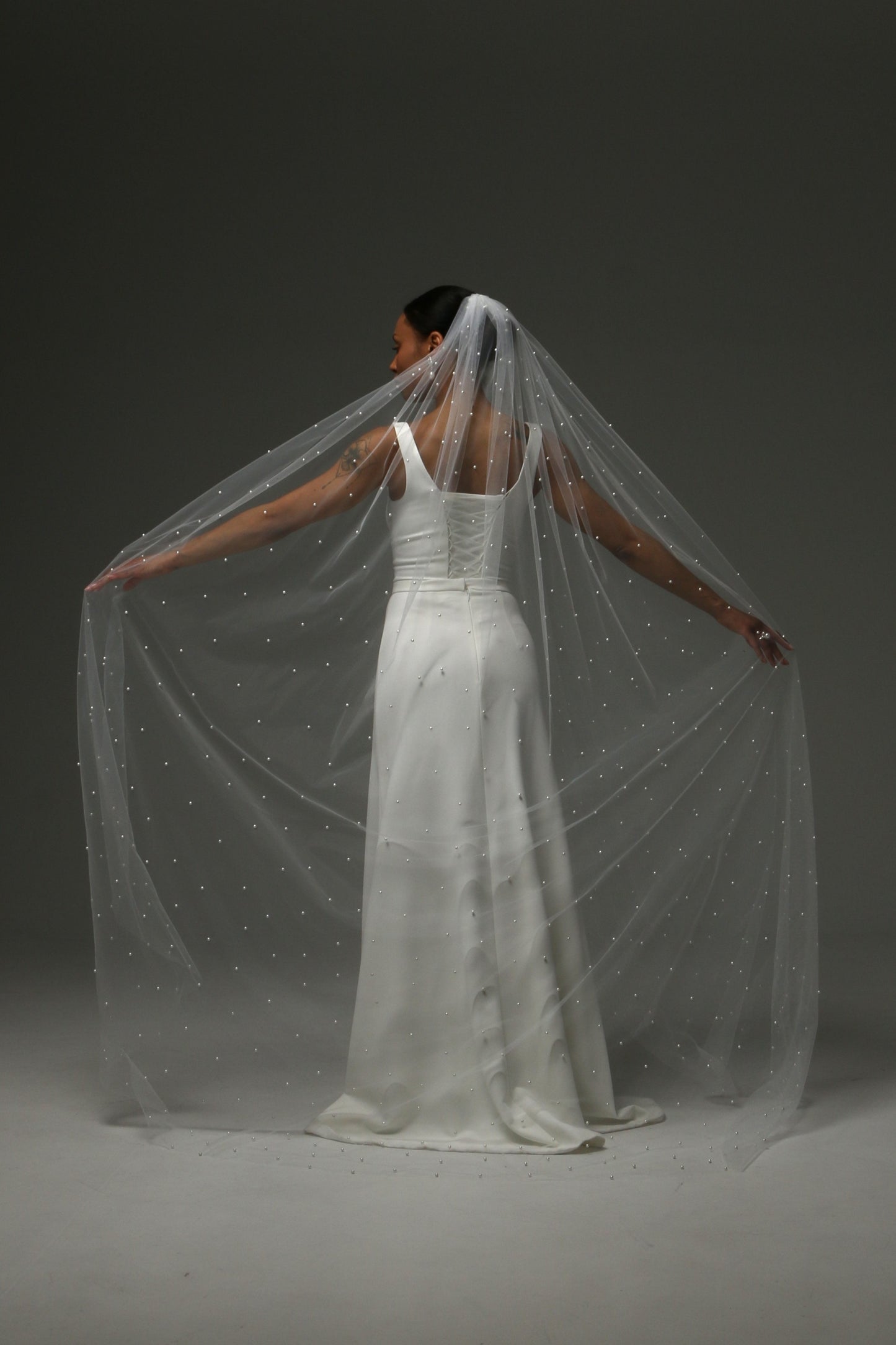 legant wedding veil with soft tulle and subtle pearl shimmer.