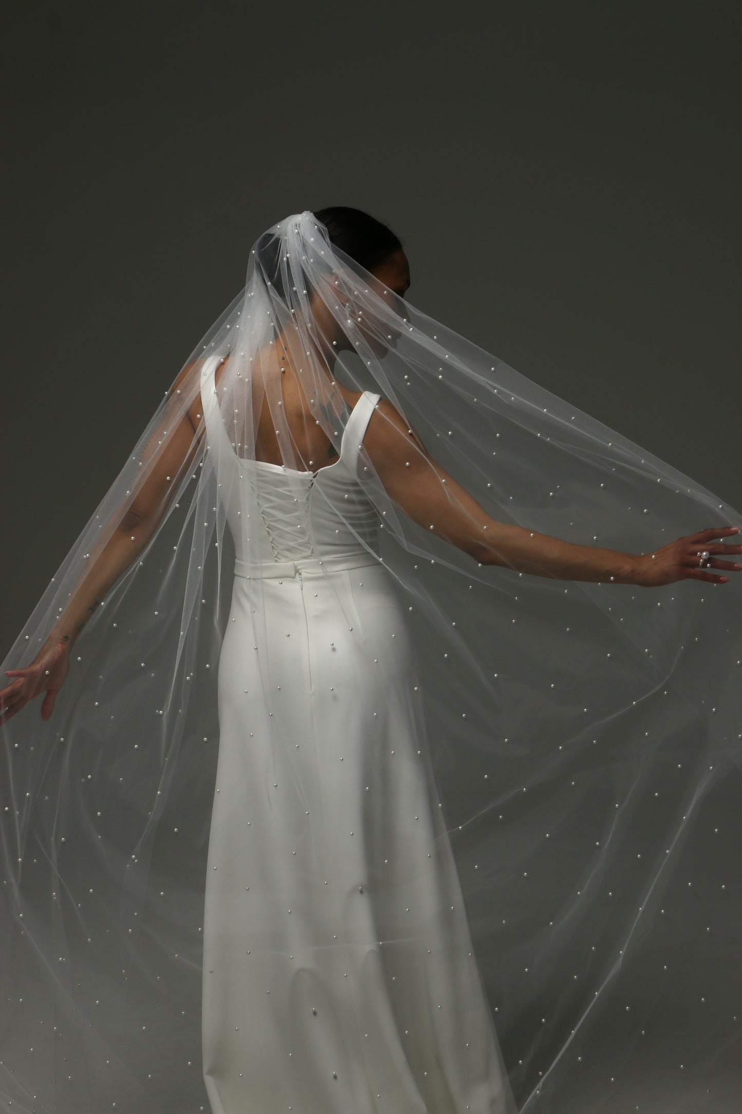 Contemporary bridal accessory featuring scattered pearl embellishments.