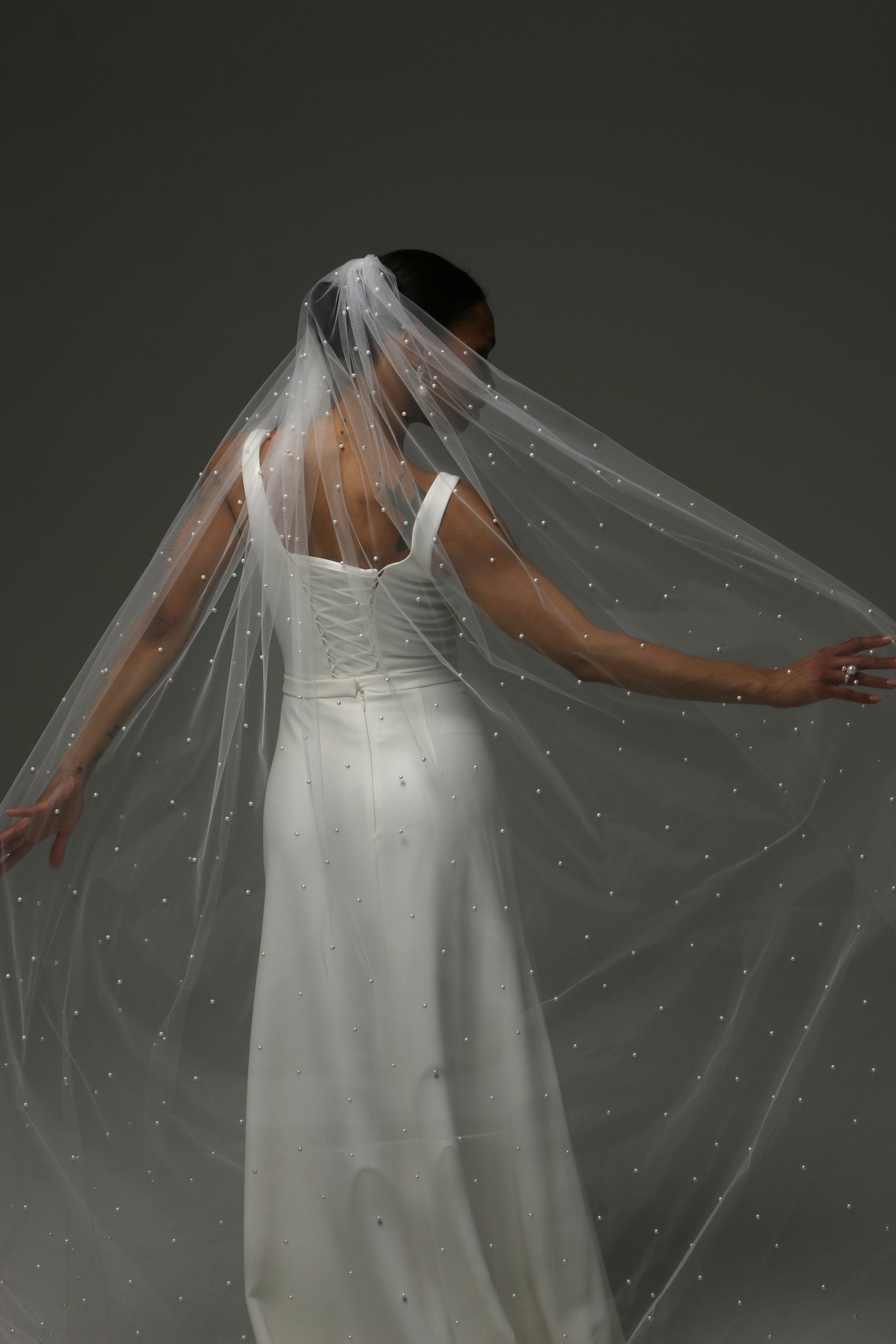 Contemporary bridal accessory featuring scattered pearl embellishments.