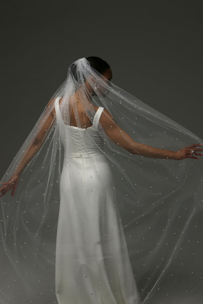 Contemporary bridal accessory featuring scattered pearl embellishments.