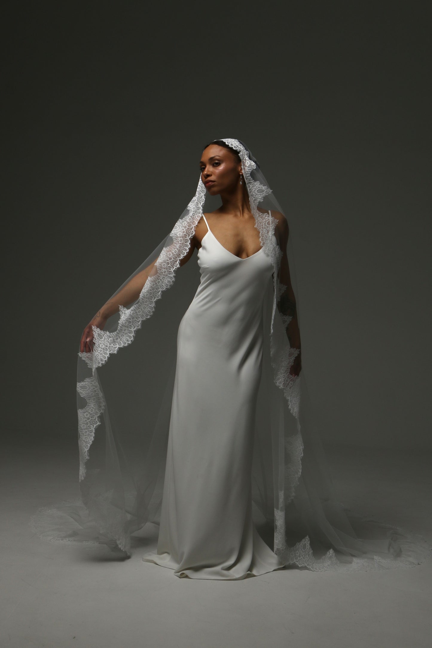 Ivory cathedral mantilla veil creating a romantic bridal silhouette.