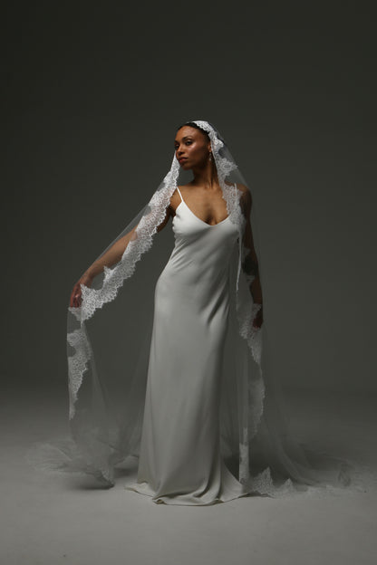 Ivory cathedral mantilla veil creating a romantic bridal silhouette.