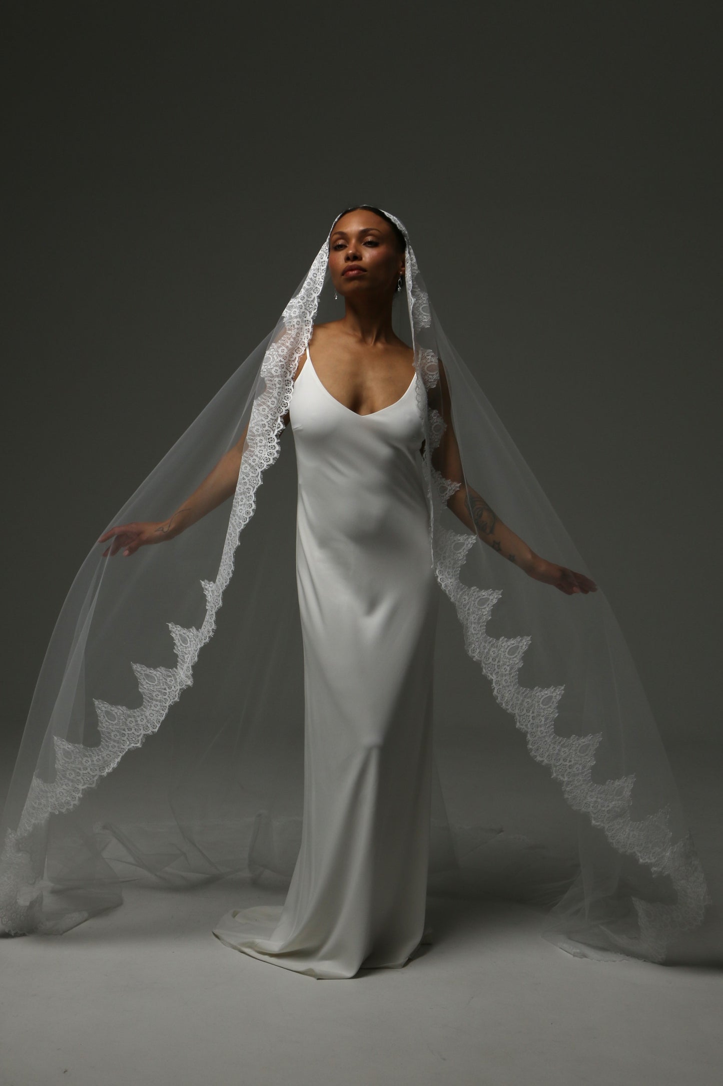 Traditional mantilla wedding veil with ornate floral lace edging.