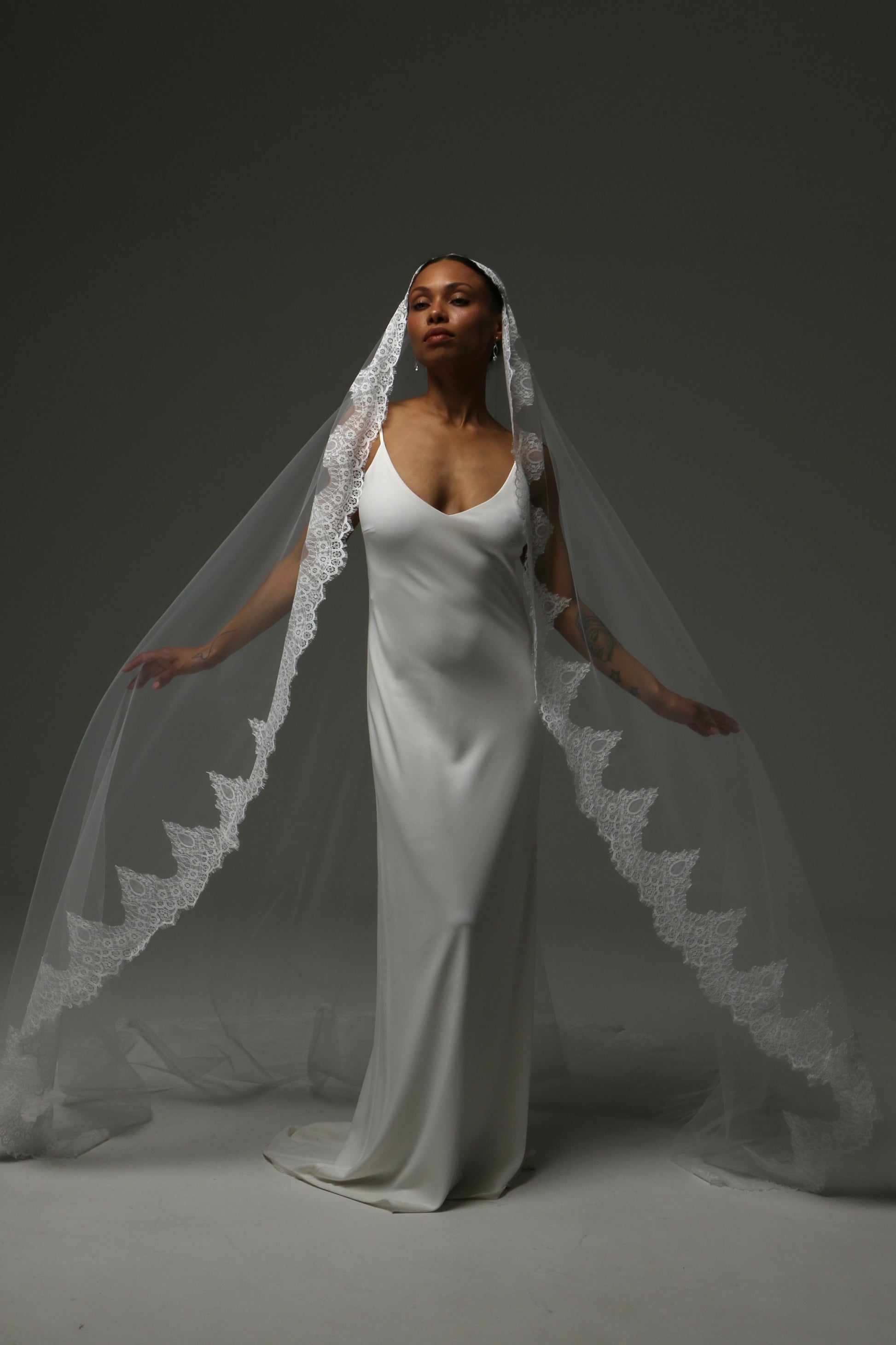Traditional mantilla wedding veil with ornate floral lace edging.