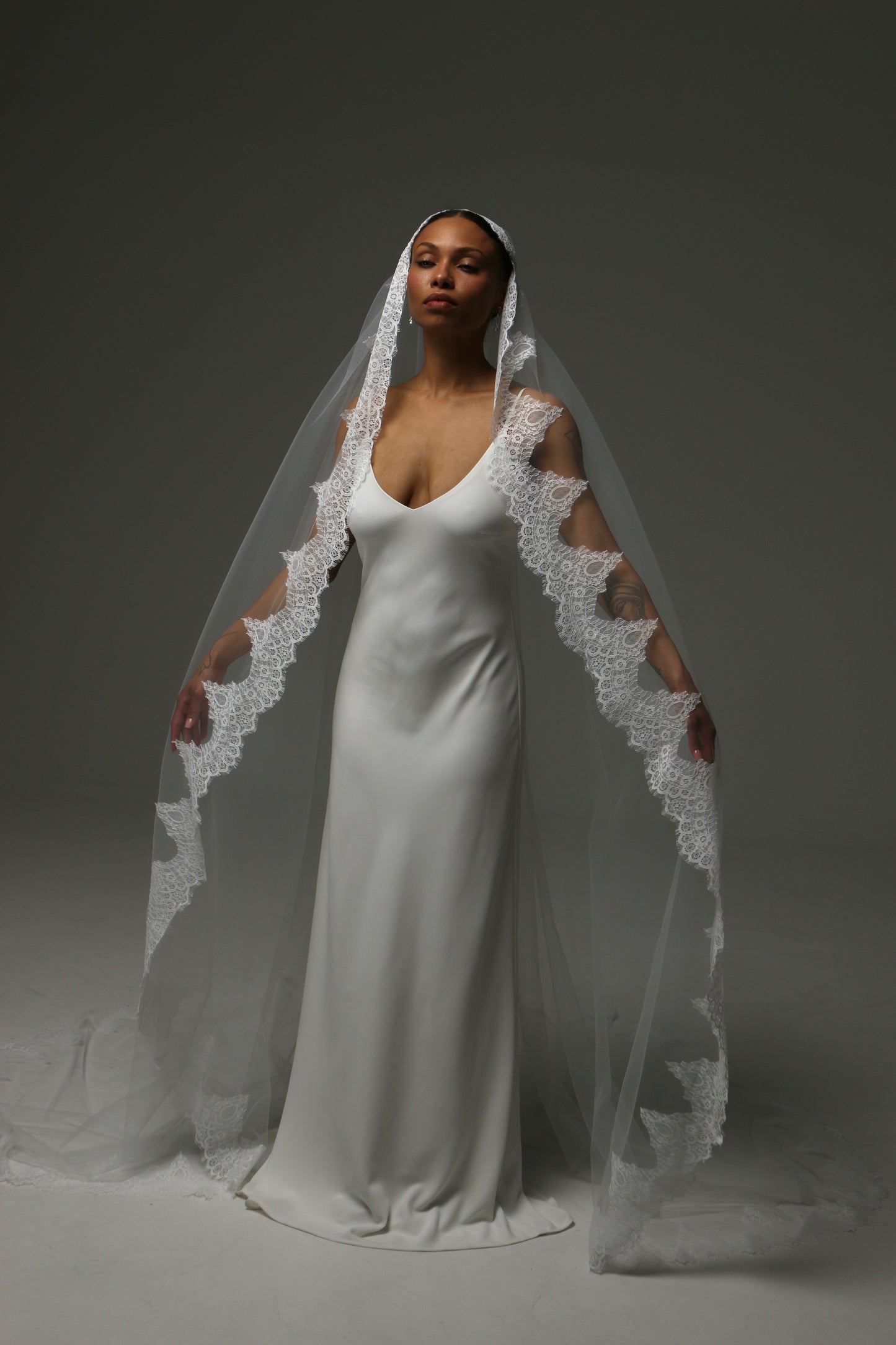 Handmade mantilla veil with intricate lace appliqué edge.