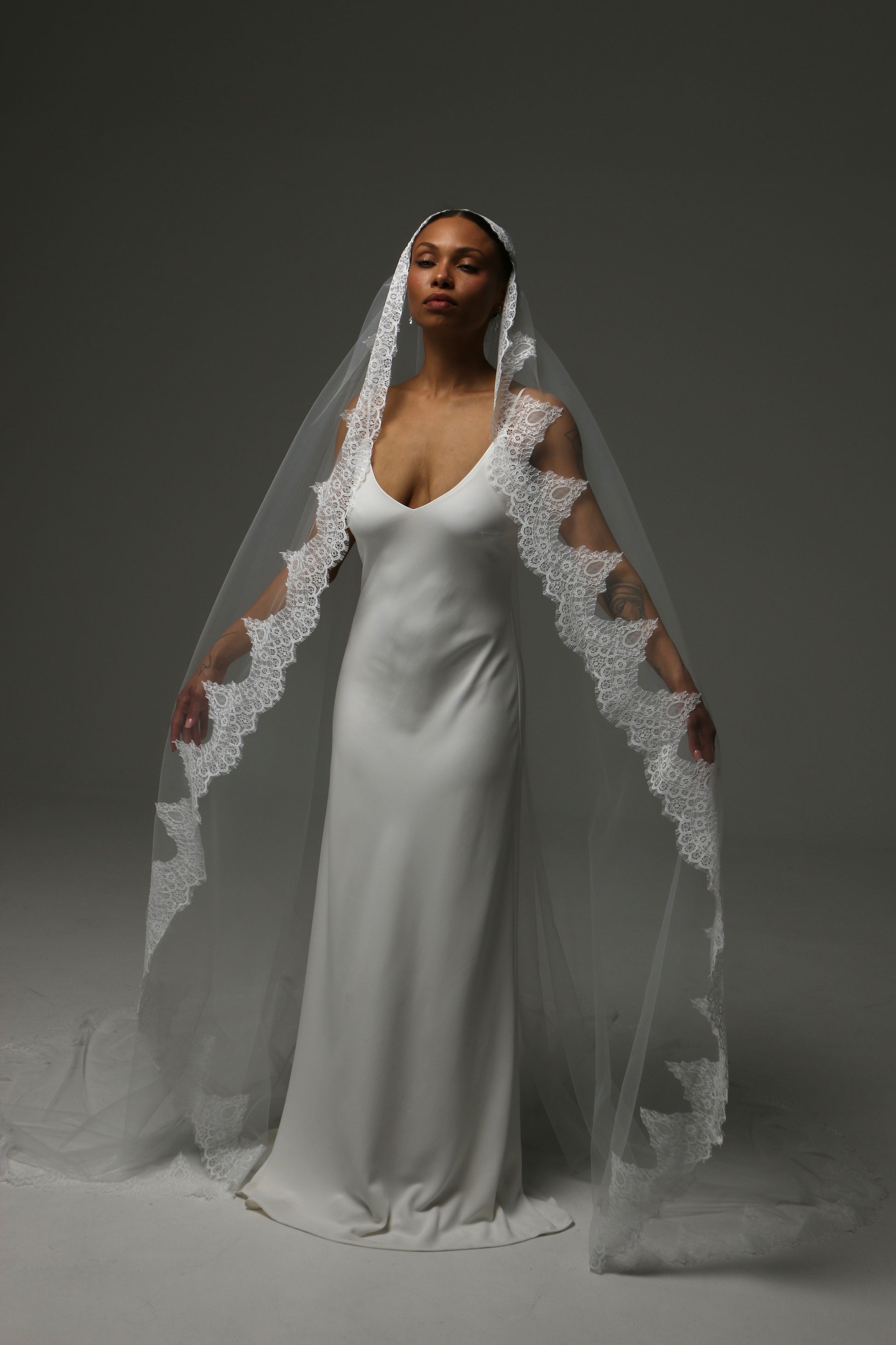 Handmade mantilla veil with intricate lace appliqué edge.