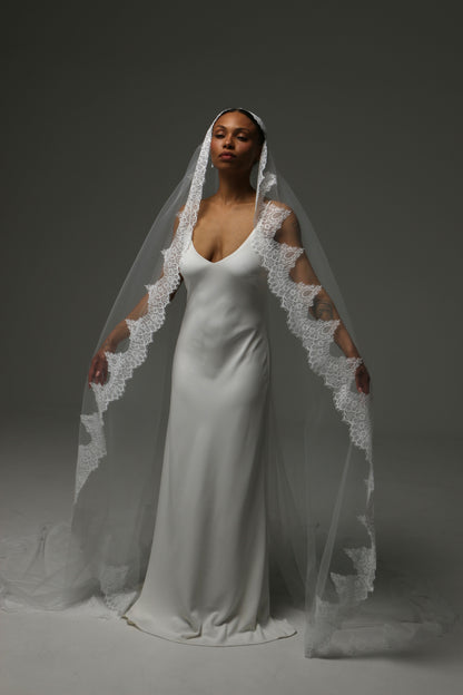 Handmade mantilla veil with intricate lace appliqué edge.