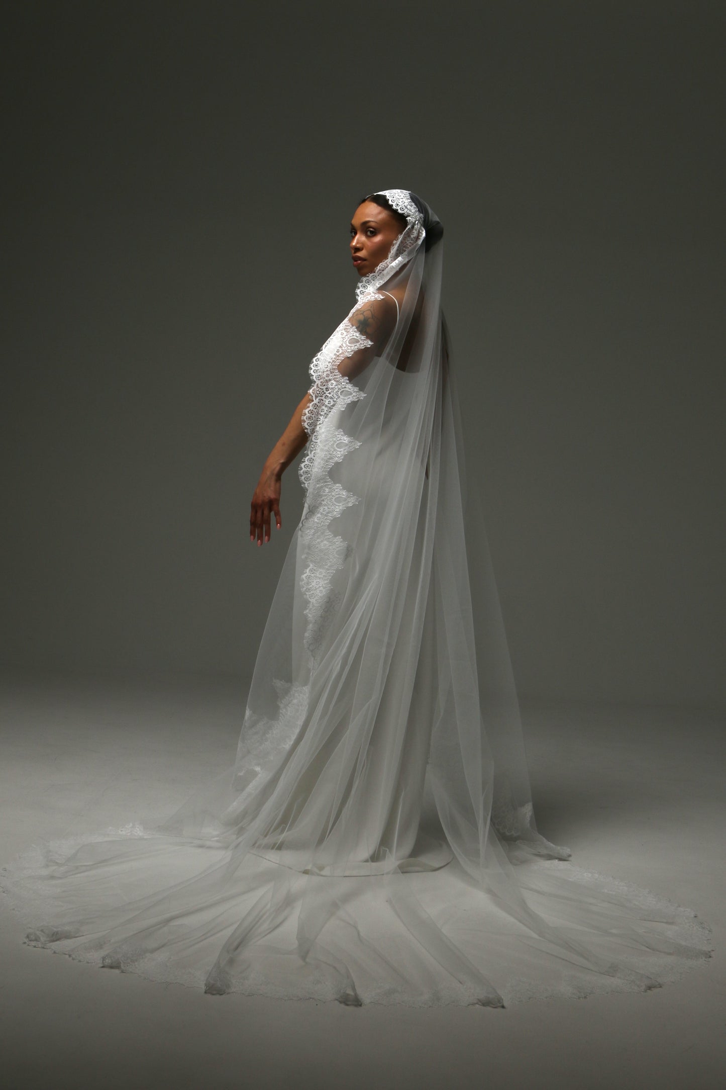Long cathedral veil with delicate floral lace framing effect.