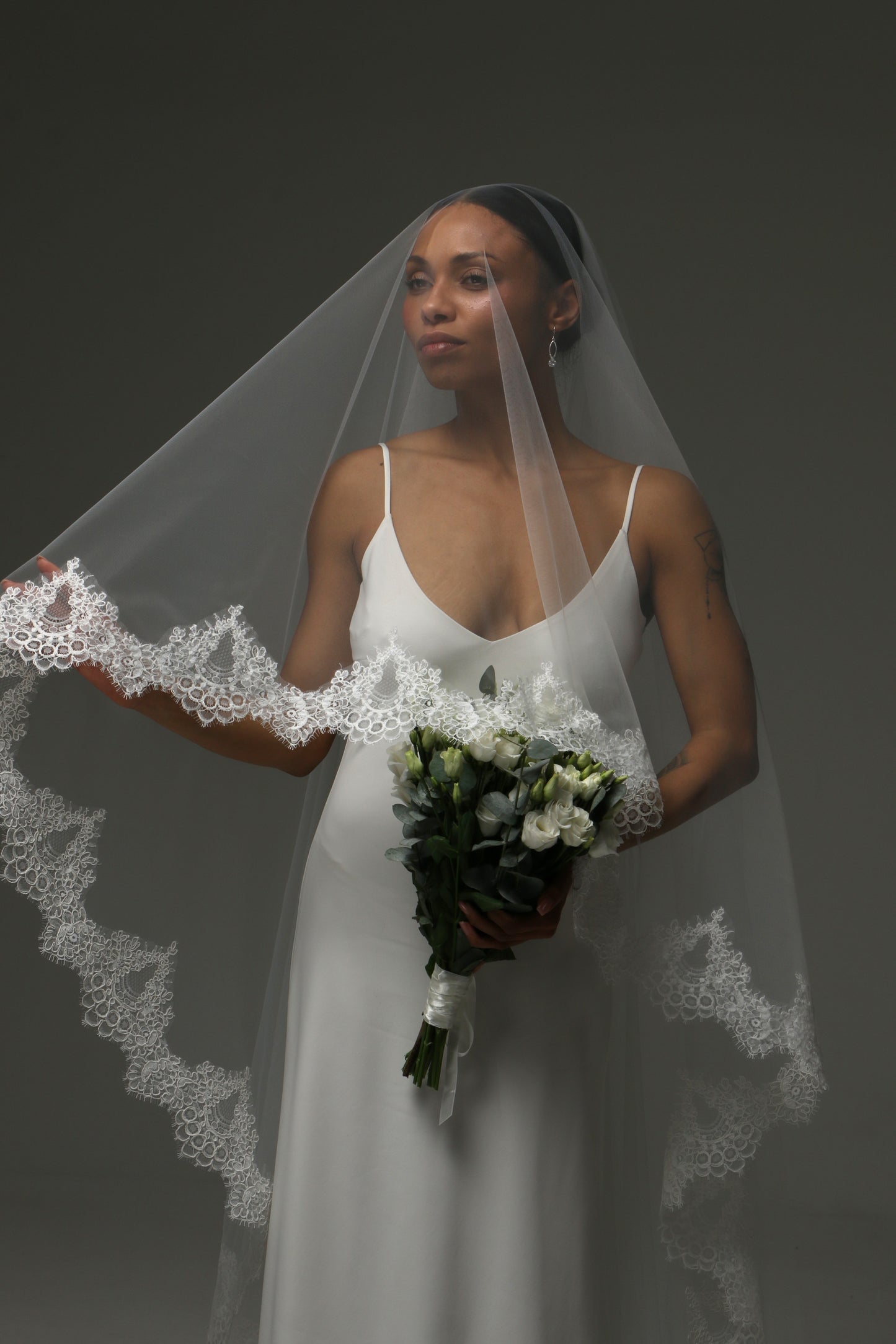 Romantic wedding veil paired with a minimalist satin gown.