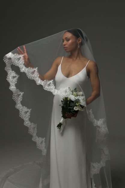 Classic wedding veil with intricate lace edge detailing.