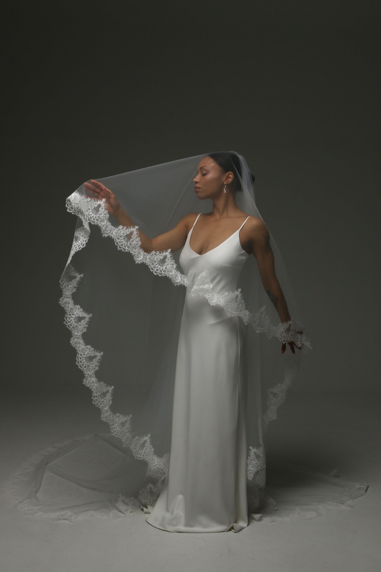 Handmade cathedral veil featuring ornate lace border.
