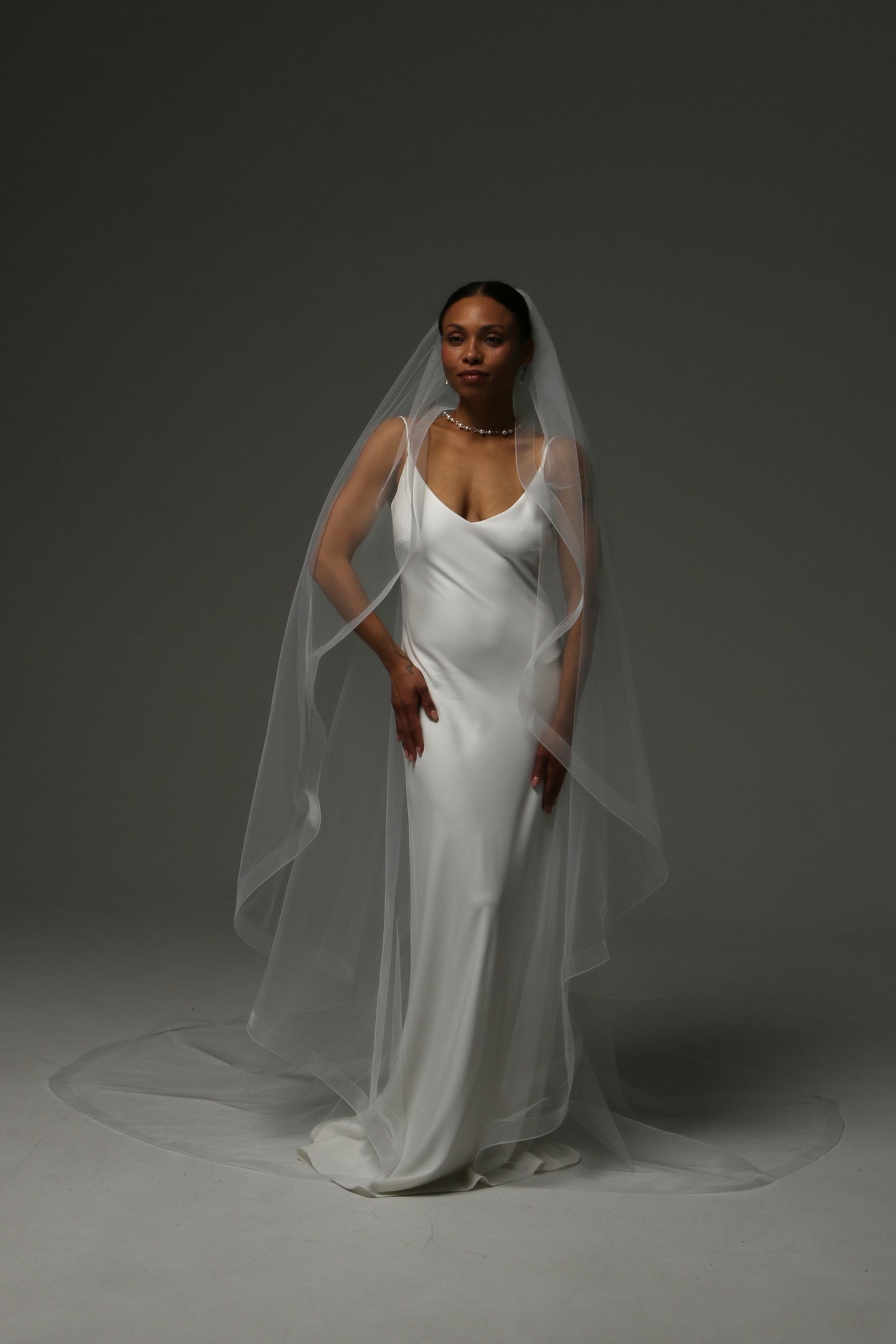 One-tier cascade cathedral wedding veil with horsehair edge trim.
