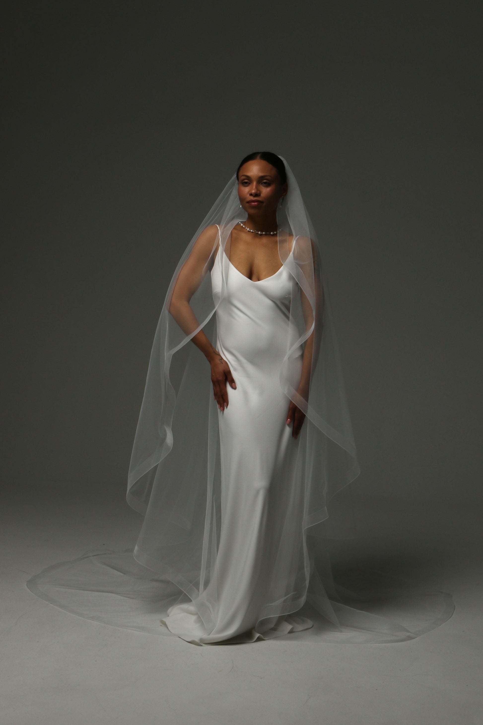 One-tier cascade cathedral wedding veil with horsehair edge trim.