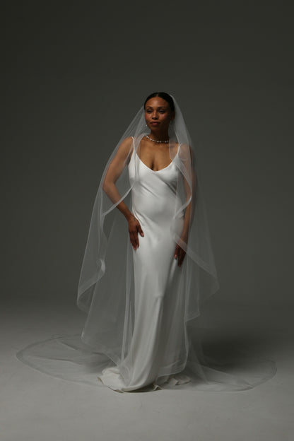 One-tier cascade cathedral wedding veil with horsehair edge trim.