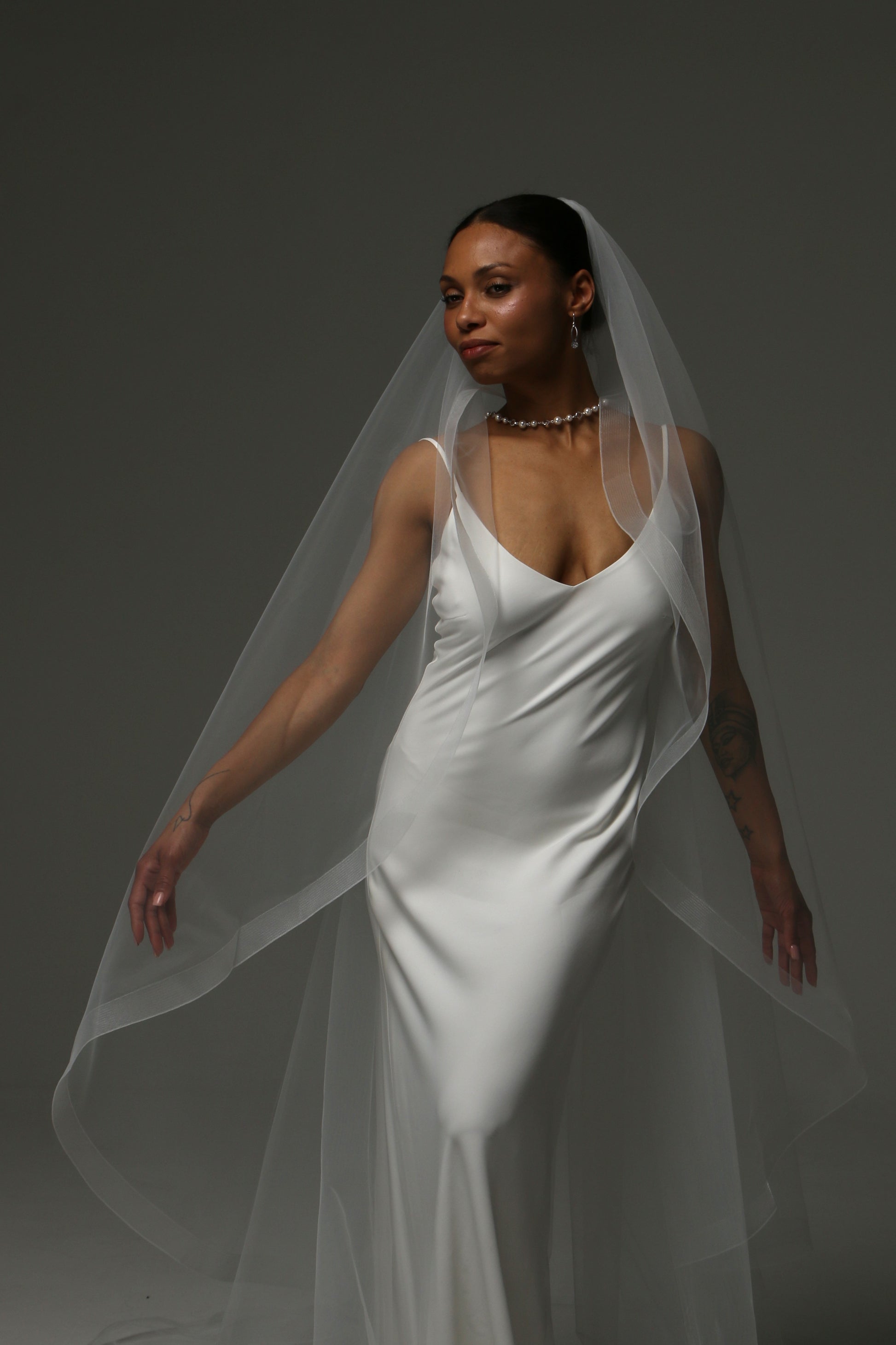Cathedral-length bridal veil featuring a structured horsehair border.