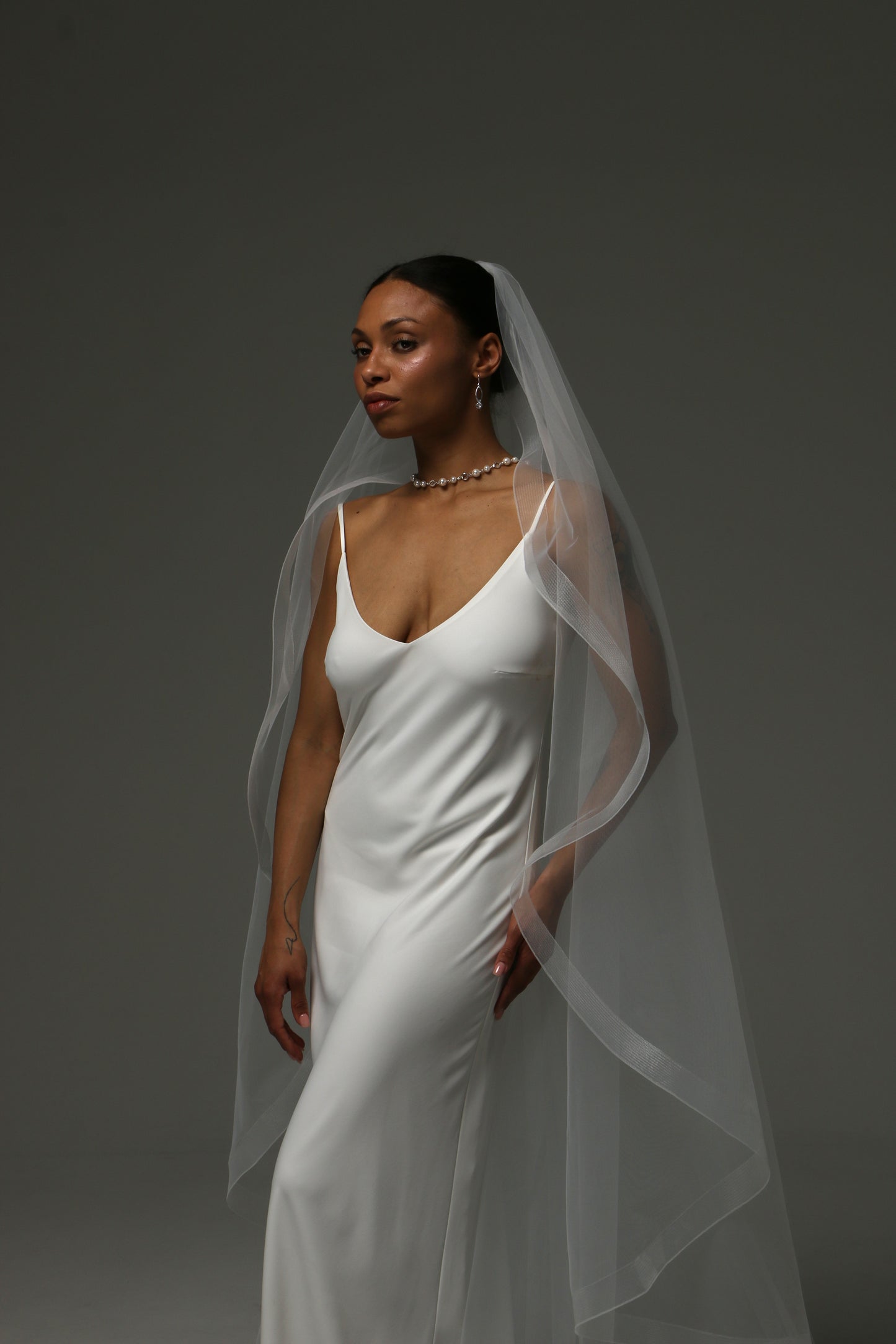 Elegant cathedral wedding veil paired with a minimalist gown.