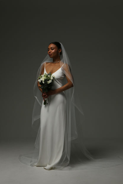 Soft tulle veil with sculpted horsehair edge and flowing silhouette.