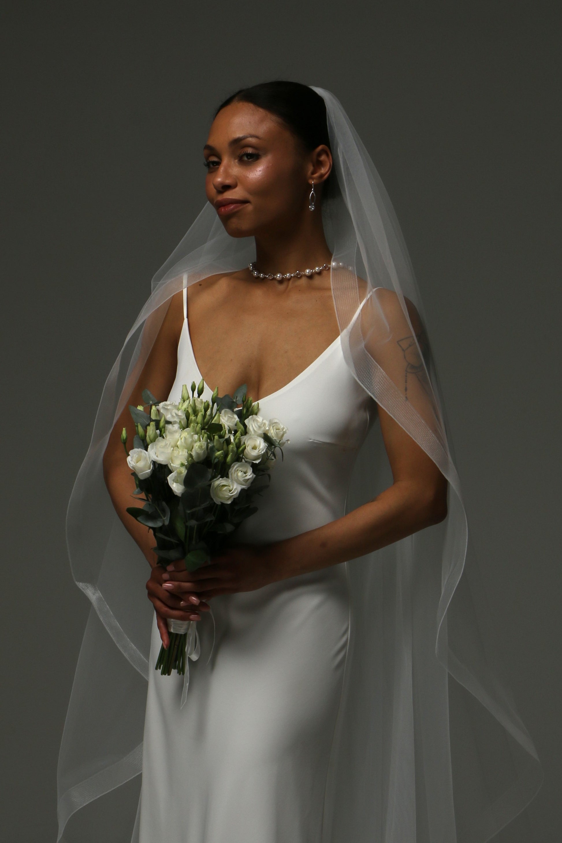 Soft illusion tulle wedding veil with elegant wave edge finish.