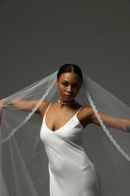 Romantic wedding veil with subtle lace detail along the edge.