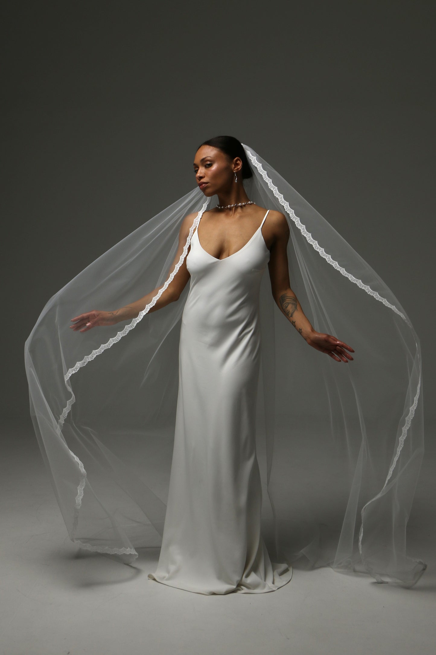 Close-up of thin lace trim on a soft tulle wedding veil.
