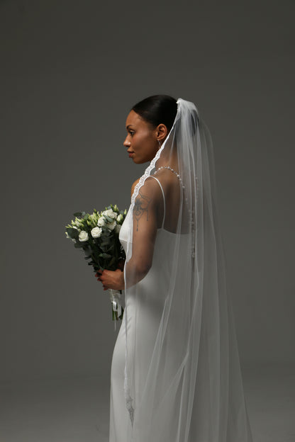 Cathedral-length bridal veil styled with a satin wedding dress.
