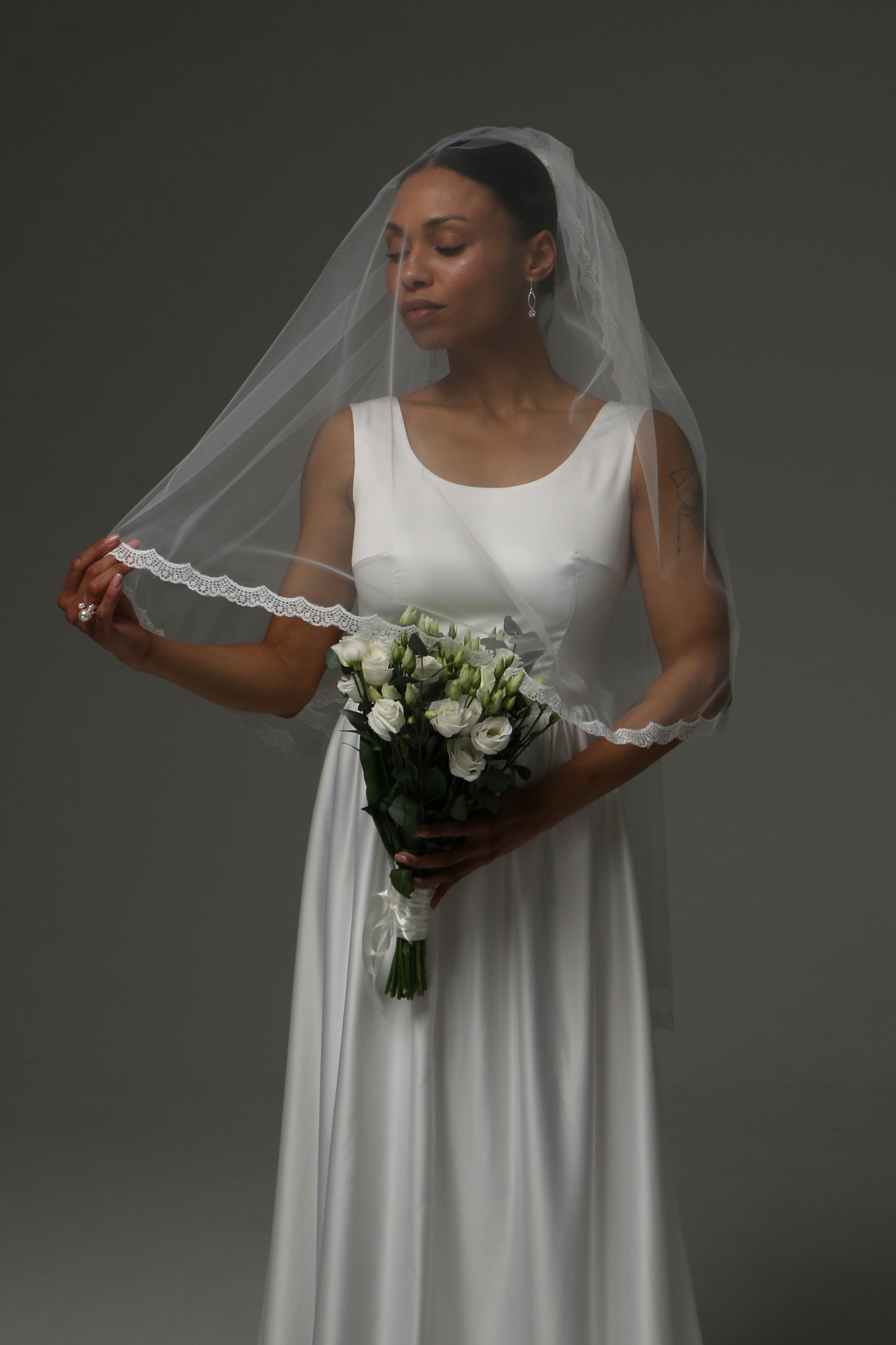 Romantic two-tier wedding veil styled with a simple bridal gown.