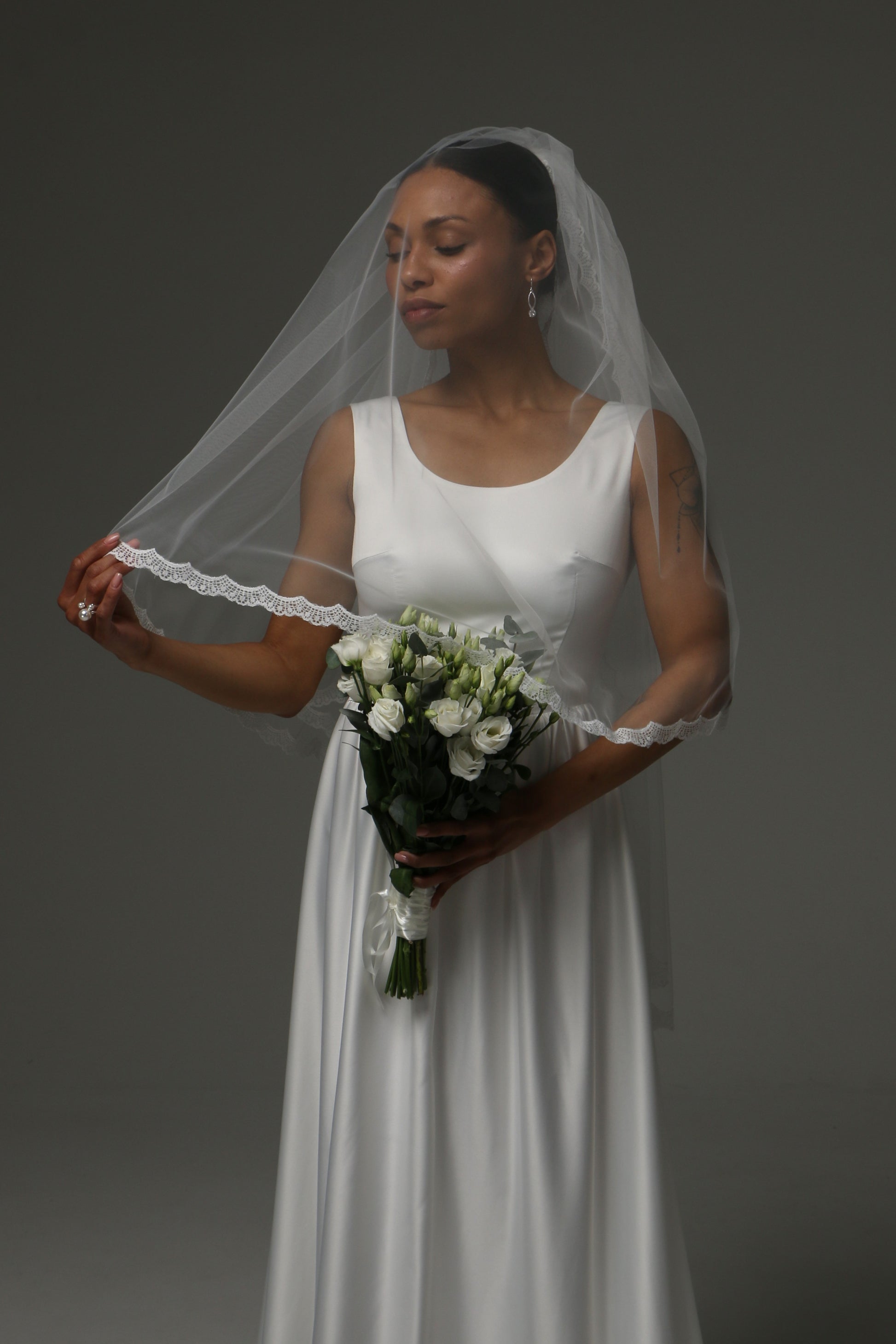 Romantic two-tier wedding veil styled with a simple bridal gown.