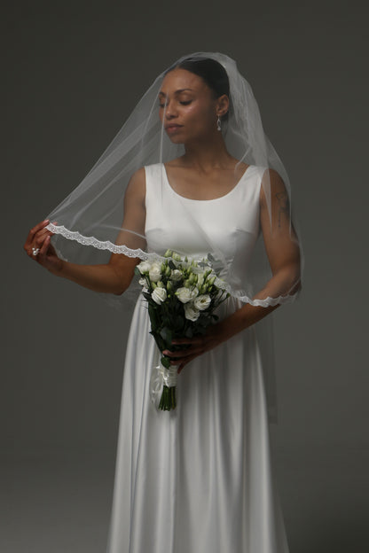 Romantic two-tier wedding veil styled with a simple bridal gown.