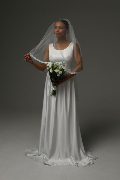 Delicate lace-edged wedding veil with airy silhouette.