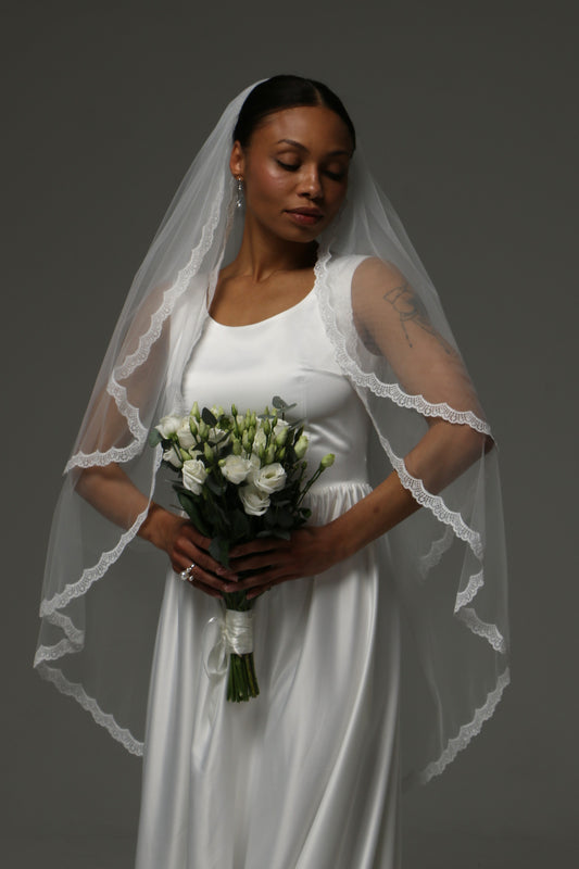 Two-tier short wedding veil with delicate lace edge and blusher.