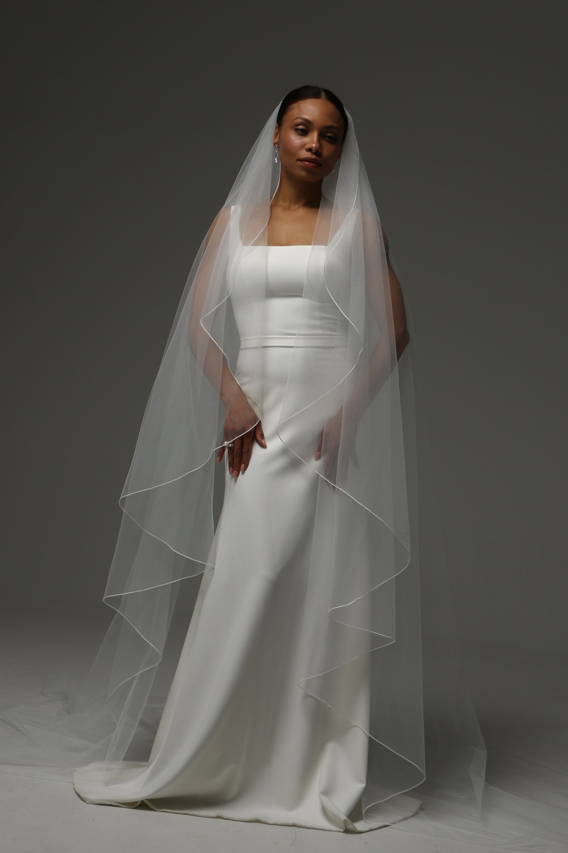 Soft illusion tulle cathedral veil with clean minimalist design.