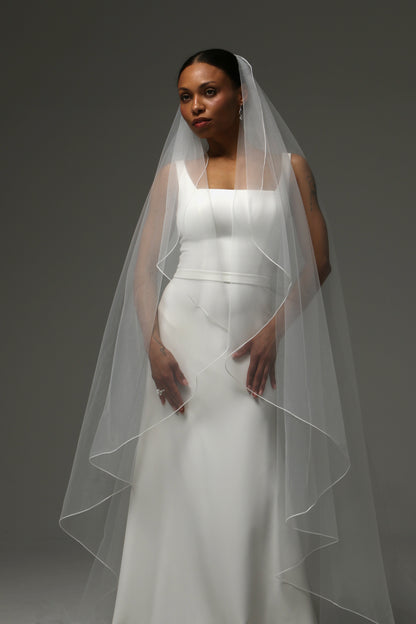 Cathedral wedding veil creating graceful movement and soft drape.