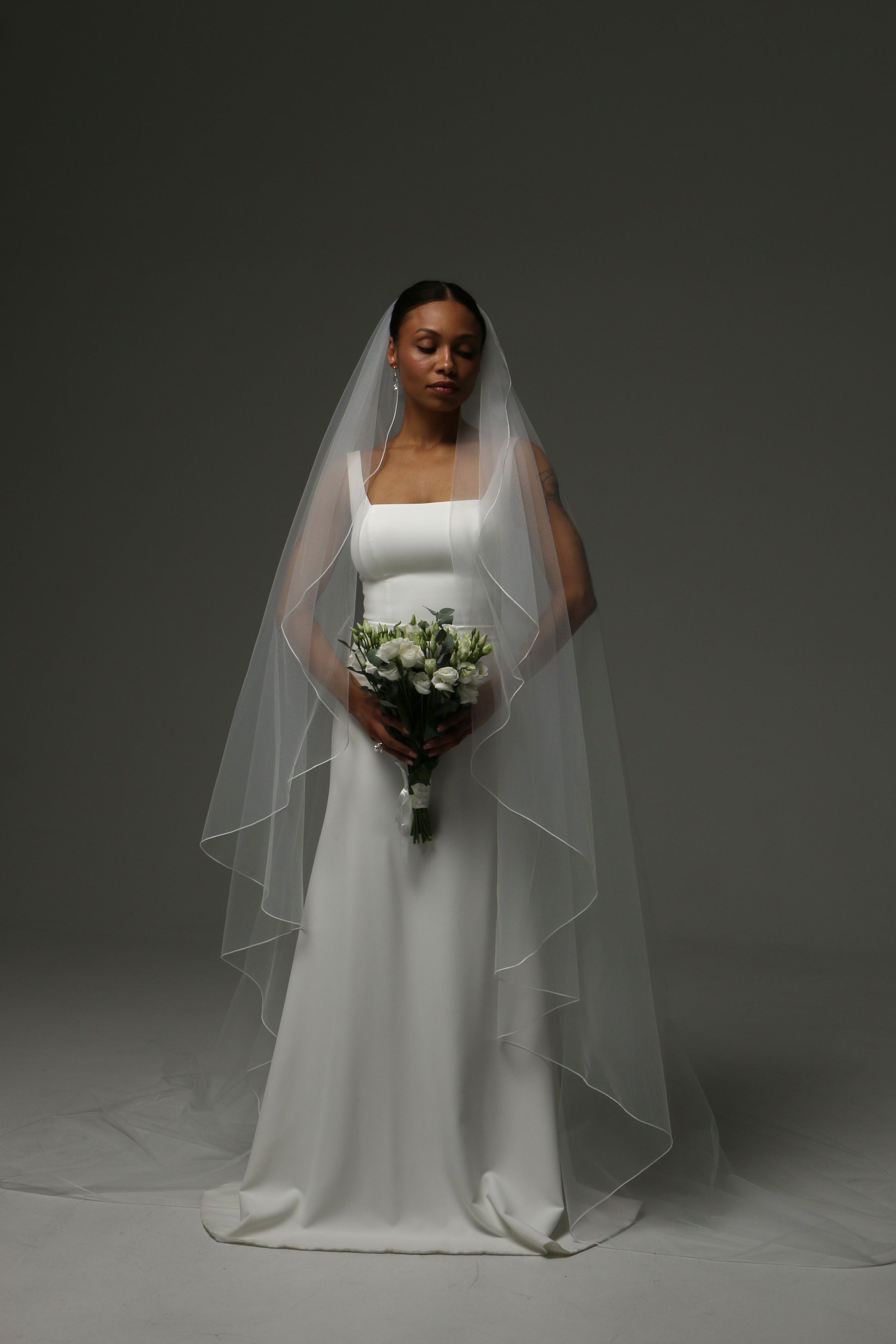 Modern bridal accessory with clean pencil edge detailing.