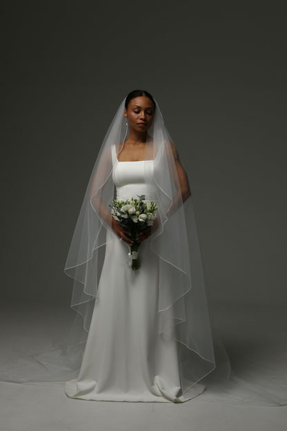 Modern bridal accessory with clean pencil edge detailing.